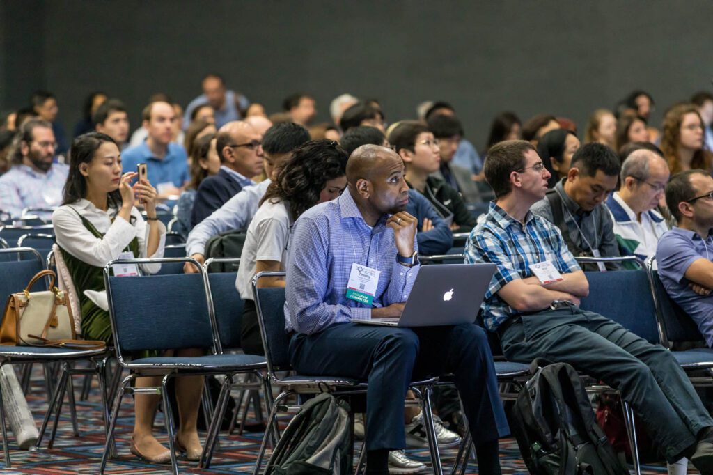 Meeting Attendee Taking notes while listening in on a session