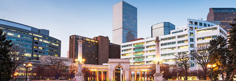 Denver, Colorado, USA downtown cityscape in Civic Center park at dusk.